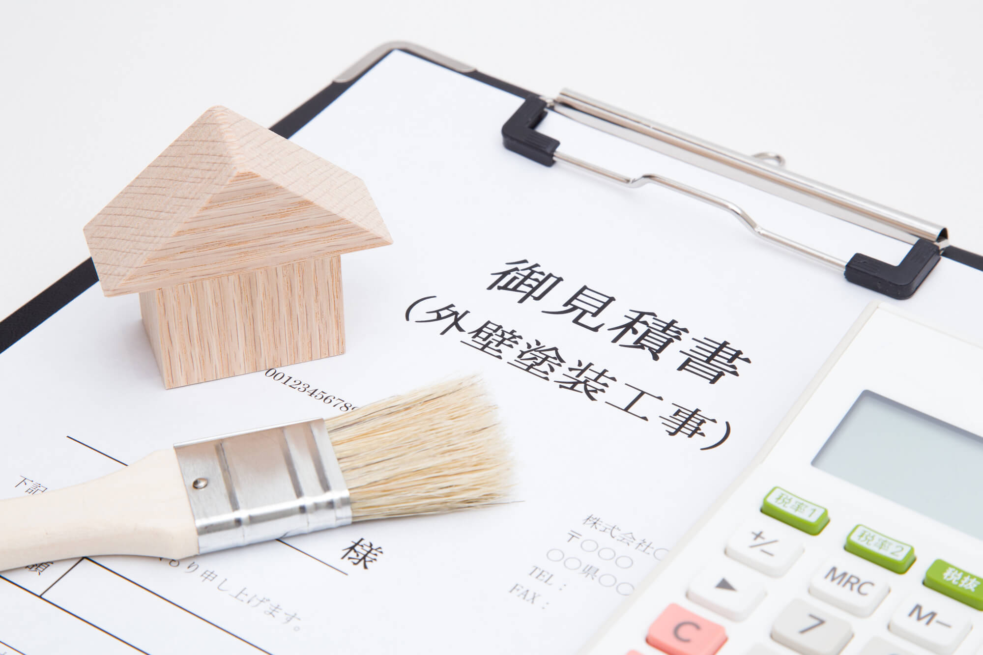 住宅と外壁塗装工事の見積書を確認するイメージ